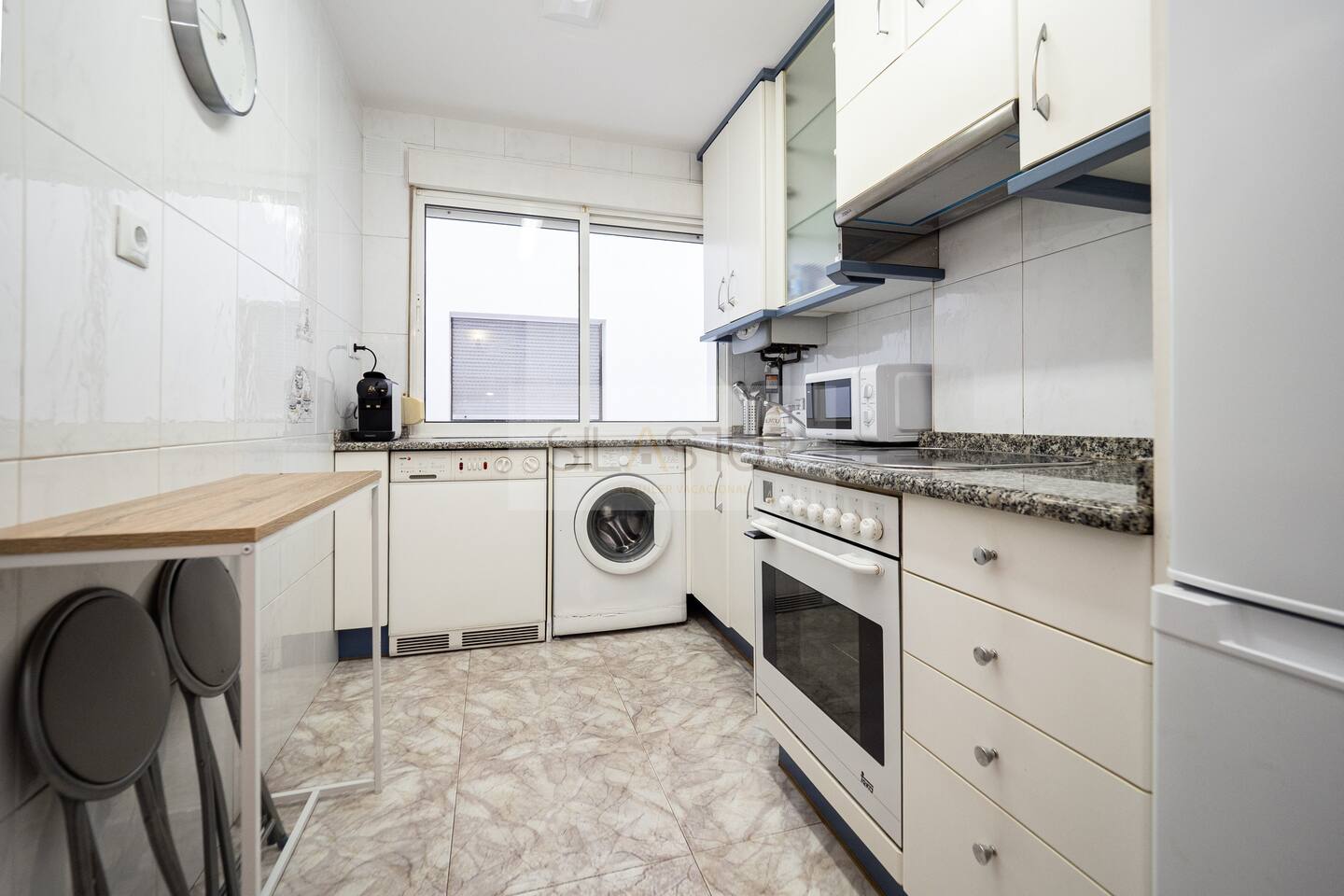 Cucina attrezzata con forno, microonde e lavatrice